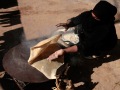 Cooking traditional bedouin bread 'Shrak'. Al-Rashidyyah village, Wadi Rum - February 2008